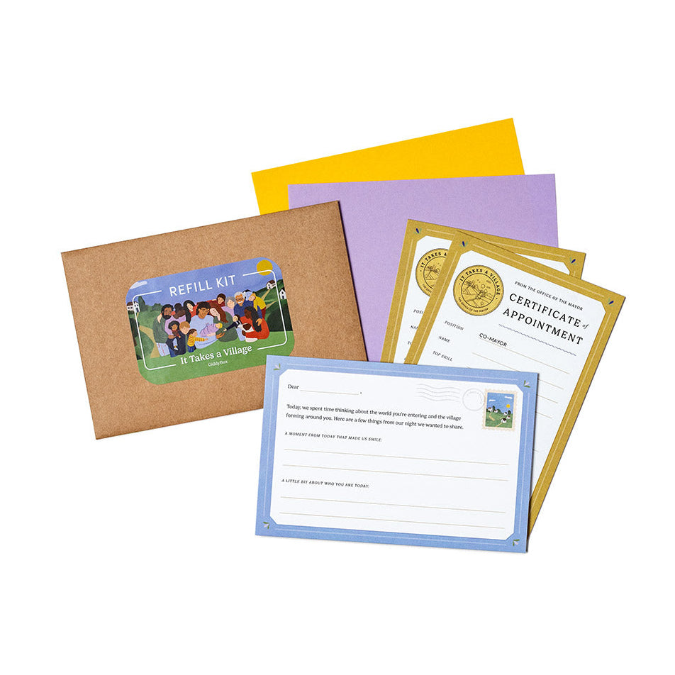 A photograph of the It Takes a Village refill kit. An envelope, with a a letter card, two Mayor cards, and yellow and purple origami sheets.