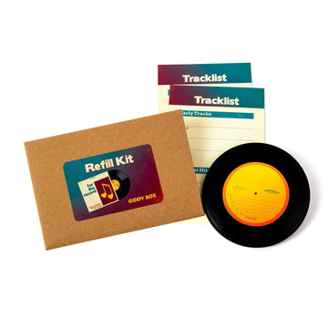 A photo of the For the Record refill kit, showing an envelope titled "refill kit," a vinyl record keepsake and two tracklist cards.